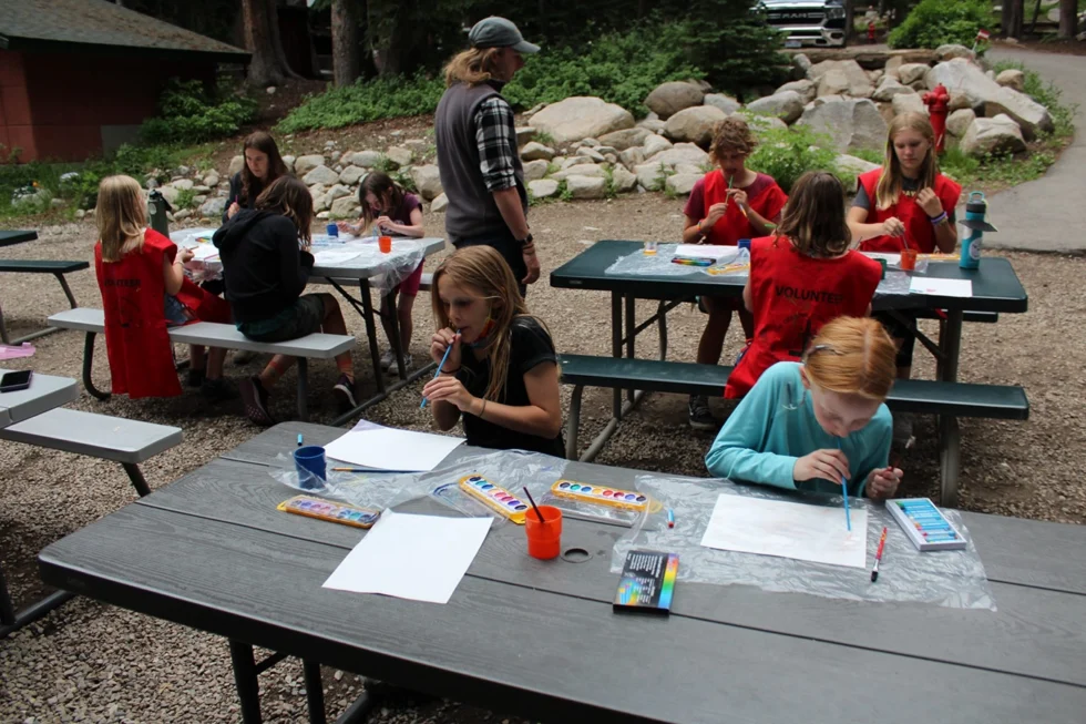 Group of attendees painting at Camp Tuttle