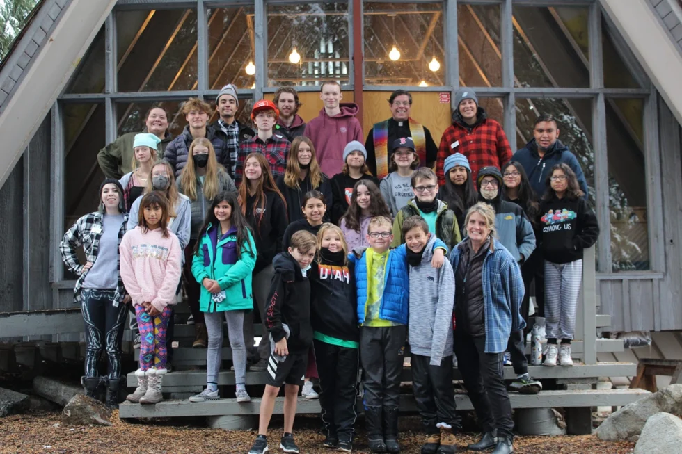 Group of attendees at Camp Tuttle outside cabin