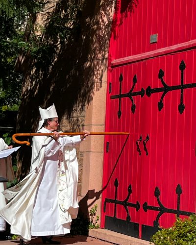 Bishop Phyllis knocking at the Cathedral doors